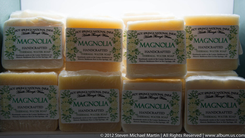 Amber soap bars in rows are labeled Magnolia handcrafted thermal water soap from Hot Springs National Park.
