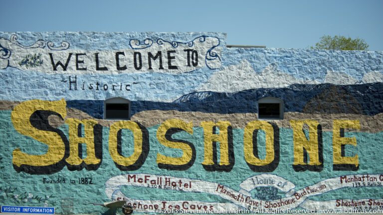 A colorful mural reads “Welcome to Historic Shoshone” above smaller local business names.