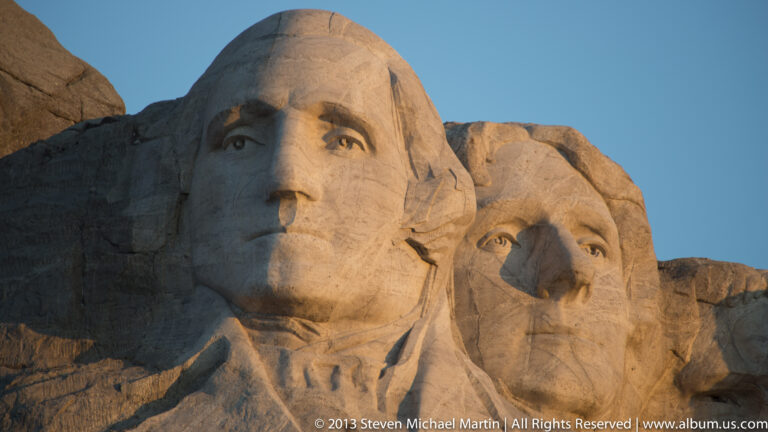 Sunlight falls across George Washington’s carved face beside the profile of Thomas Jefferson.