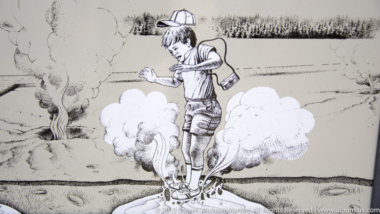 A black-and-white illustration shows a child in a hat among stylized clouds and a geyser plume.