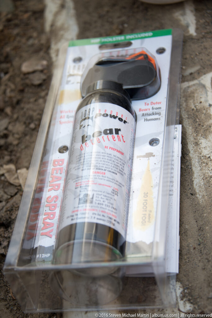 A folded printed page with small text and images lies under clear plastic on gravel.