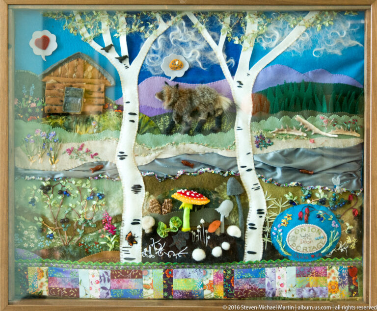 A museum panel layers birch trees, wildlife, plants, a small dwelling, and patterned decorative bands.