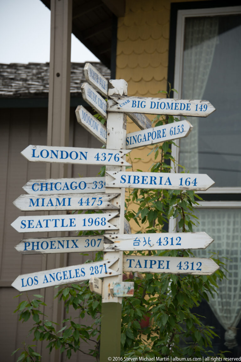 Painted arrows point to cities and places including London, Chicago, Siberia, Singapore, and Big Diomede.