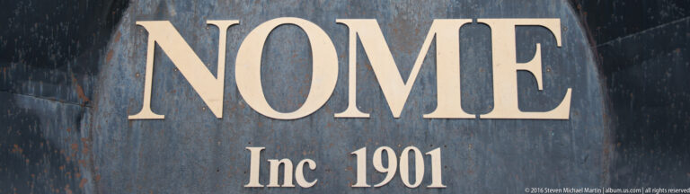 Raised letters on a dark blue panel read “NOME” and “Inc. 1901.”
