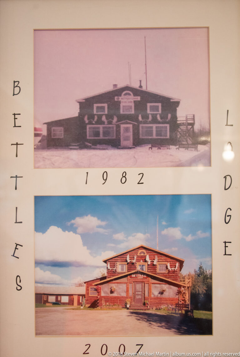 Display board with black-and-white 1982 and color 2007 photographs of a lodge.
