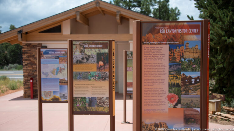 Interpretive displays outside the Red Canyon Visitor Center include maps and regional photographs.