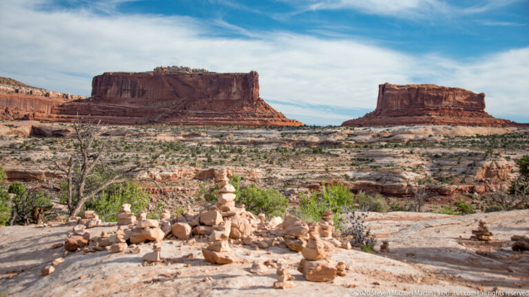 Stone cairns sit on a rocky overlook before the Monitor and Merrimac buttes.
