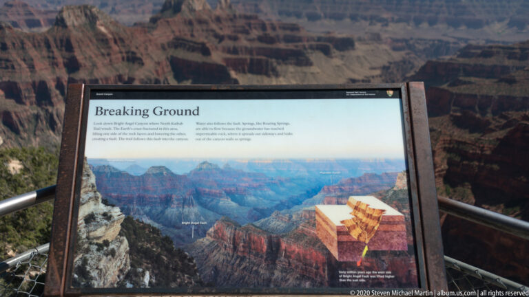 An interpretive panel titled “Breaking Ground” displays a canyon illustration and rock-layer diagram.