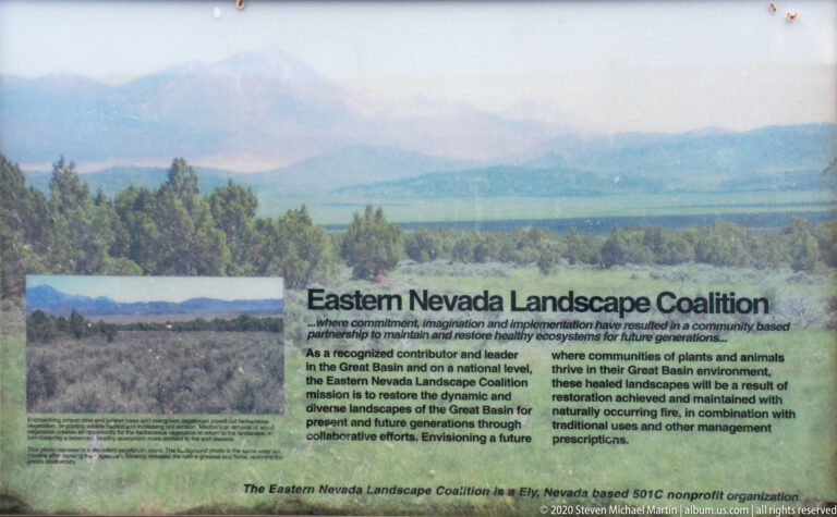 An Eastern Nevada Landscape Coalition sign presents conservation text over a valley landscape image.