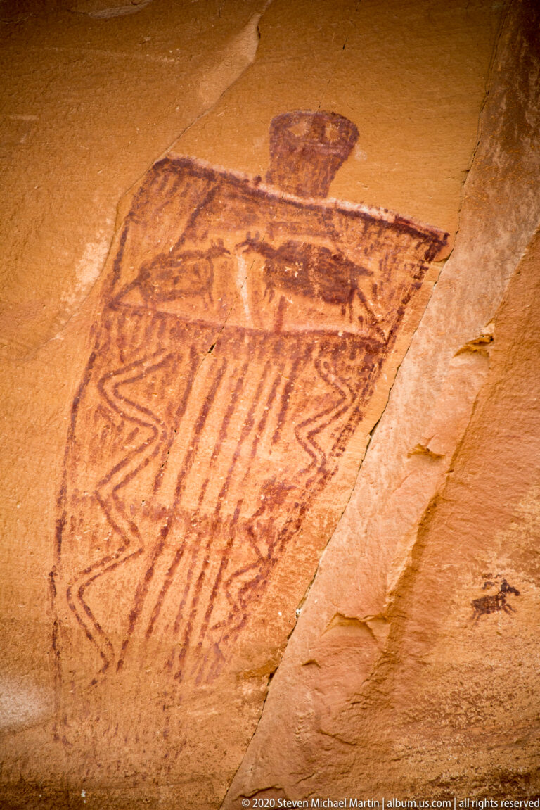 A tilted outlined figure contains stripes and zigzag bands, with a rounded mark above it.