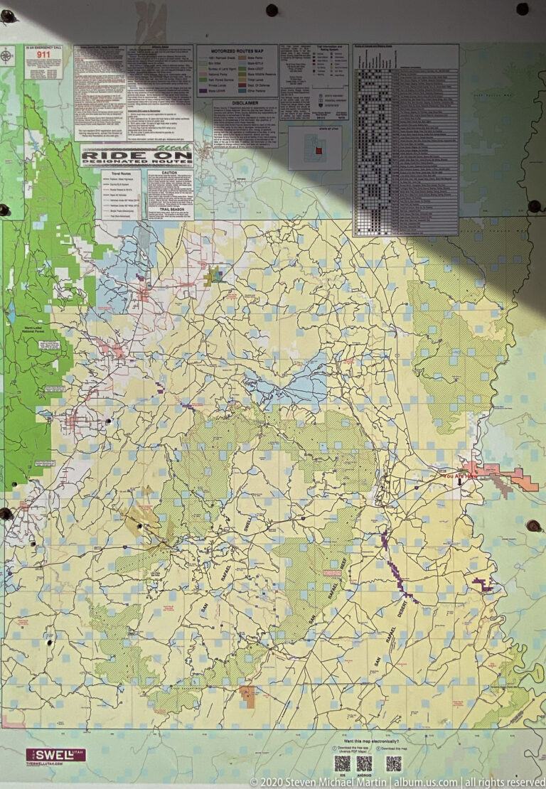 A large regional road map with route markings, a legend, posted notices, and a small locator inset.