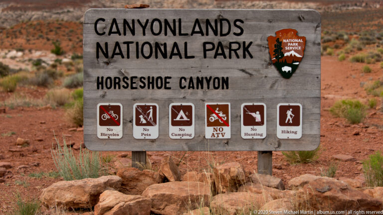 A close view of the Horseshoe Canyon sign lists restrictions on bicycles, pets, camping, ATVs, and hunting.