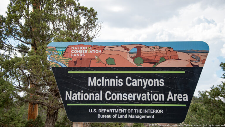 A sign names McInnis Canyons National Conservation Area and the Bureau of Land Management.