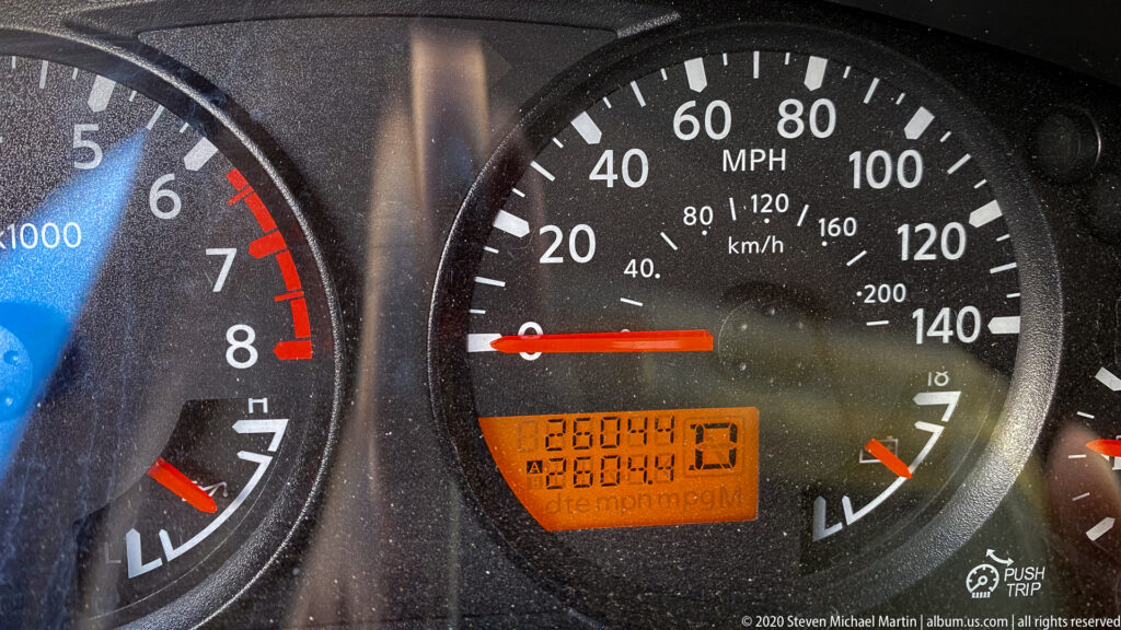 A dashboard speedometer marked in miles and kilometers per hour shows its needle at zero.