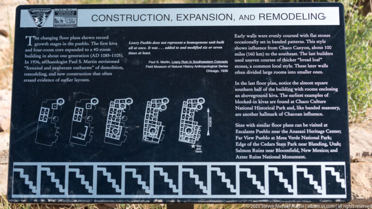 A sign compares several pueblo floor plans beneath a construction-history heading at Lowry Pueblo.
