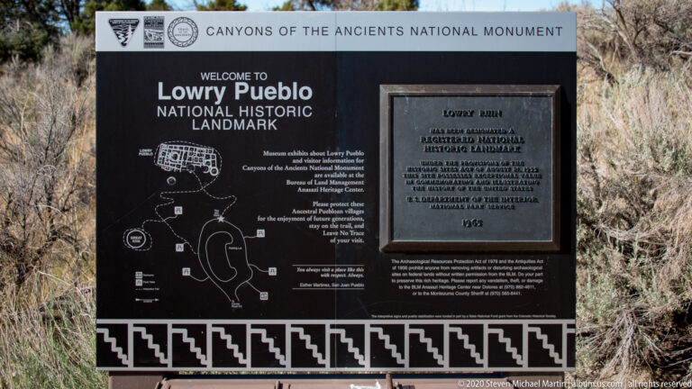 A Lowry Pueblo National Historic Landmark sign displays a site diagram and plaque.