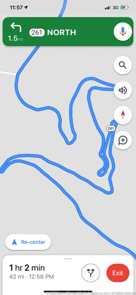 A phone screen displays a winding blue route, northbound guidance, and an estimated travel time.
