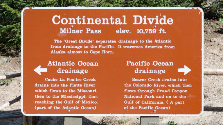 A sign at Milner Pass explains the Continental Divide and Atlantic and Pacific drainage.
