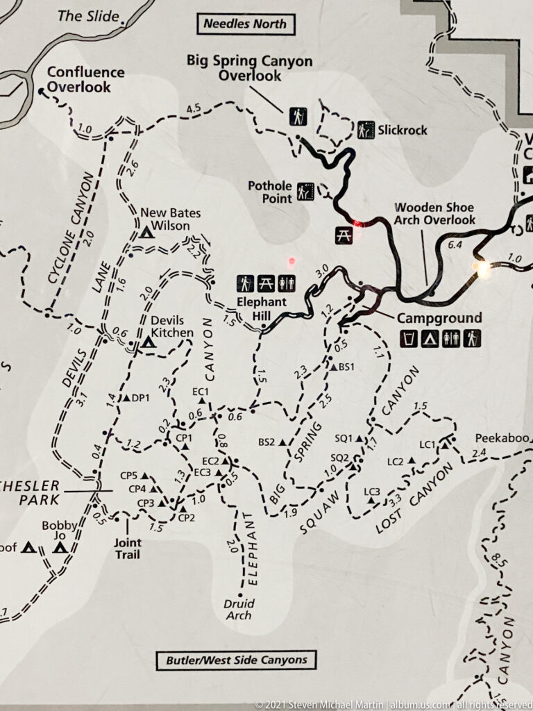 A trail map labels Druid Arch, Elephant Canyon, Chesler Park, and several routes in the Needles area.