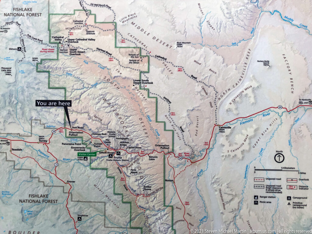 A printed map marks roads and park boundaries, with a “You are here” arrow near the western park.