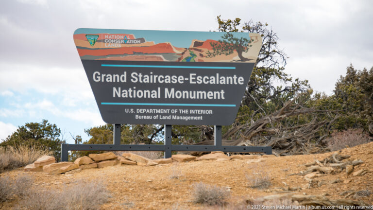 A sign identifies Grand Staircase-Escalante National Monument and names the Bureau of Land Management.