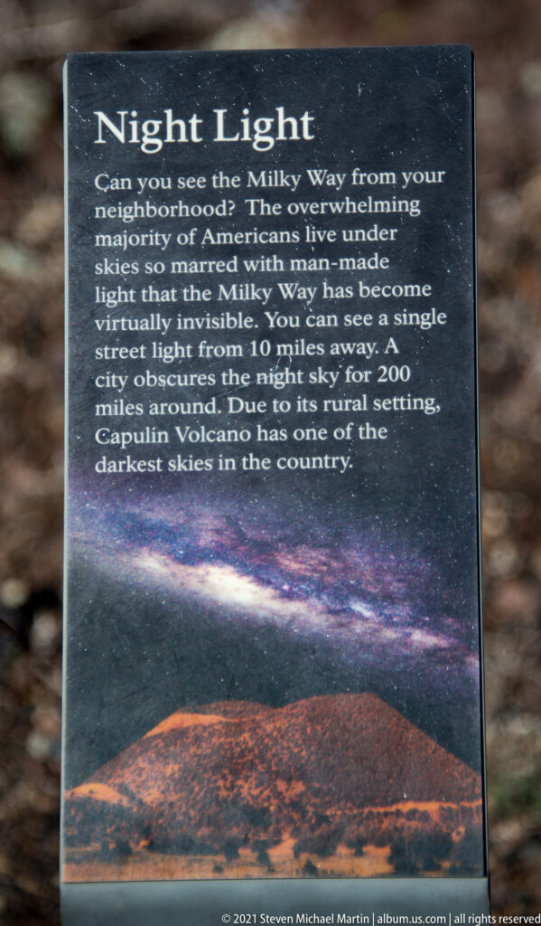 A dark “Night Light” sign discusses the Milky Way above an illustration of a starry sky and volcano.