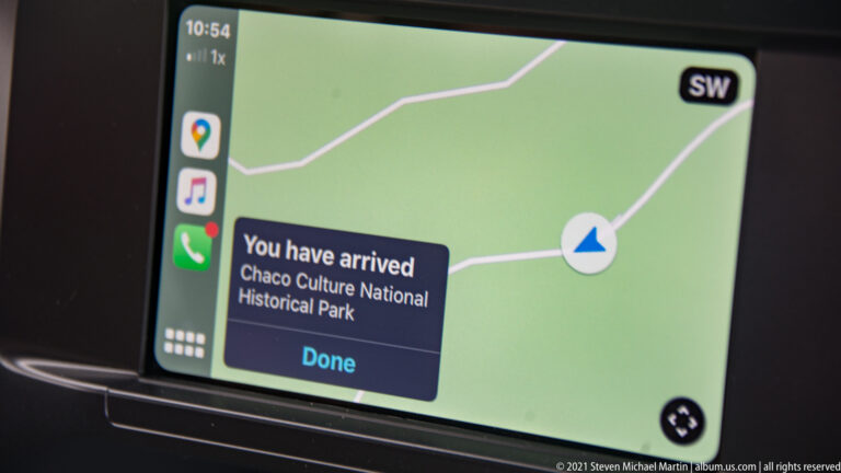 A dashboard navigation screen displays an arrival message for Chaco Culture National Historical Park over a map.