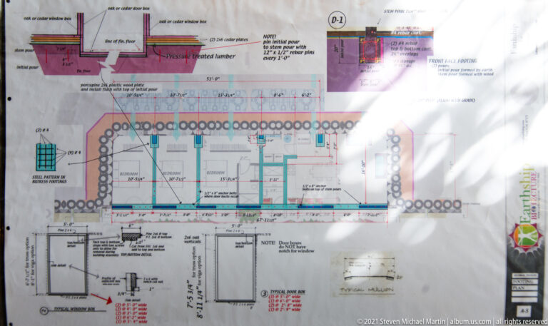 A technical sheet shows a long building plan, construction details, dimensions, and notes.