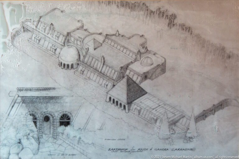 A pencil axonometric drawing shows linked rectangular wings and rounded rooms in a long building.