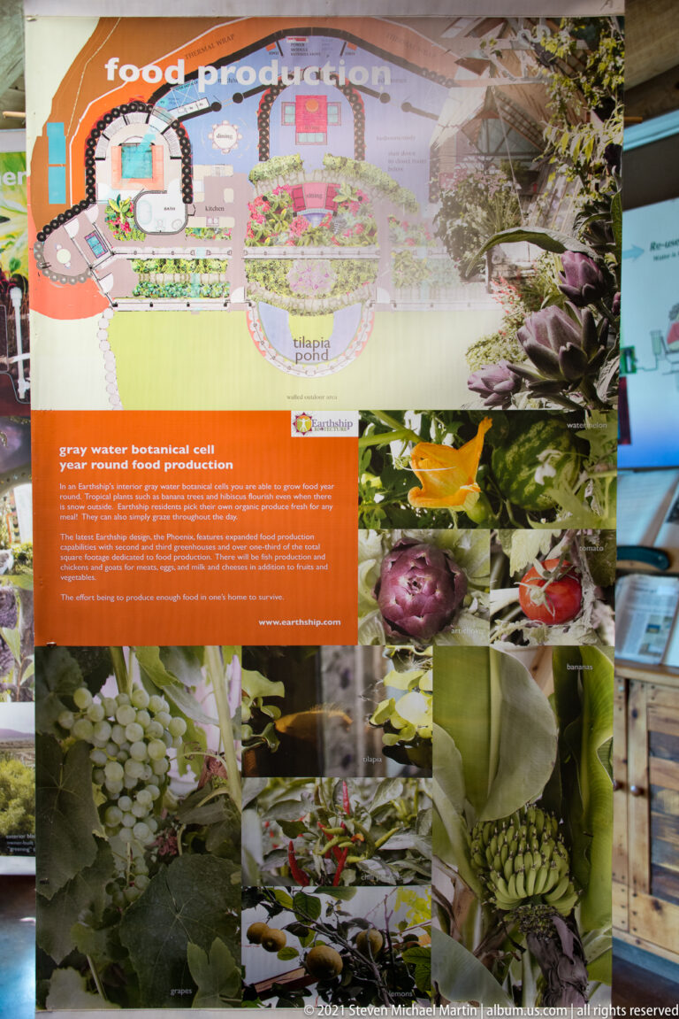 An educational display combines a food-production diagram, orange text panel, and photographs of plants and produce.