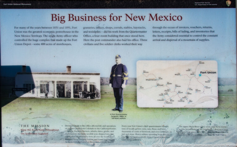 Interpretive panel with a historic building photograph, uniformed figure, regional map, and text about Fort Union’s business role.