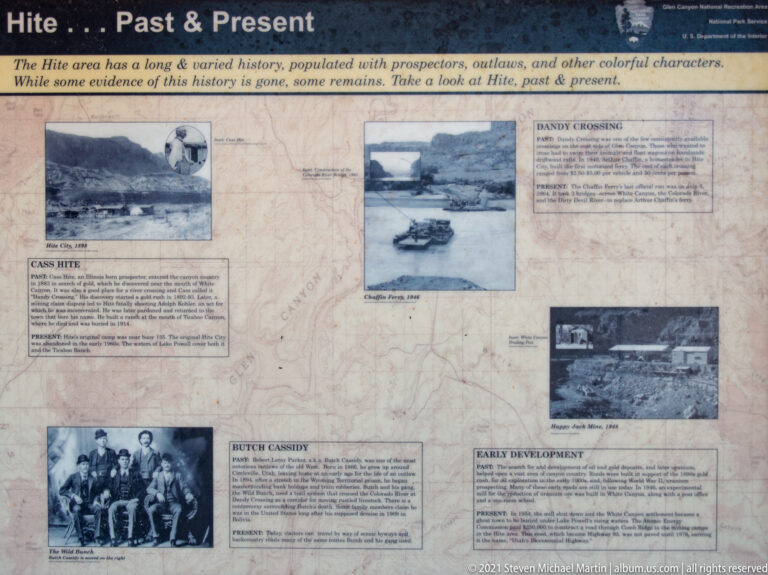 An outdoor interpretive panel displays historic photographs, a map, and explanatory text beneath “The Past and Present.”