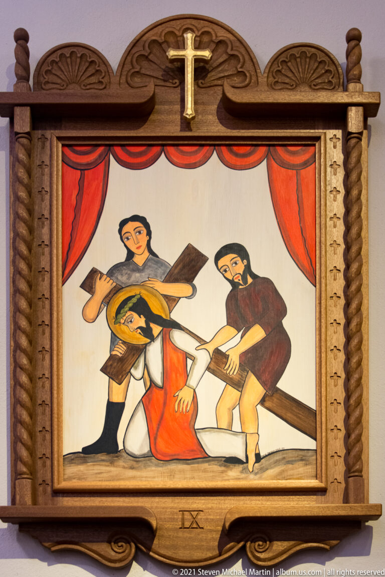 Framed painting shows Christ kneeling beneath a cross while two men stand beside him; IX is carved below.