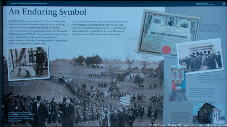 A blue exhibit panel titled “A Living Symbol” presents archival photographs, a document, and explanatory text.