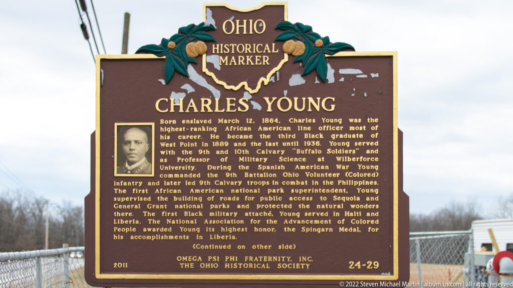 A portrait of Charles Young and gold biographical text appear on the front of an Ohio historical marker.