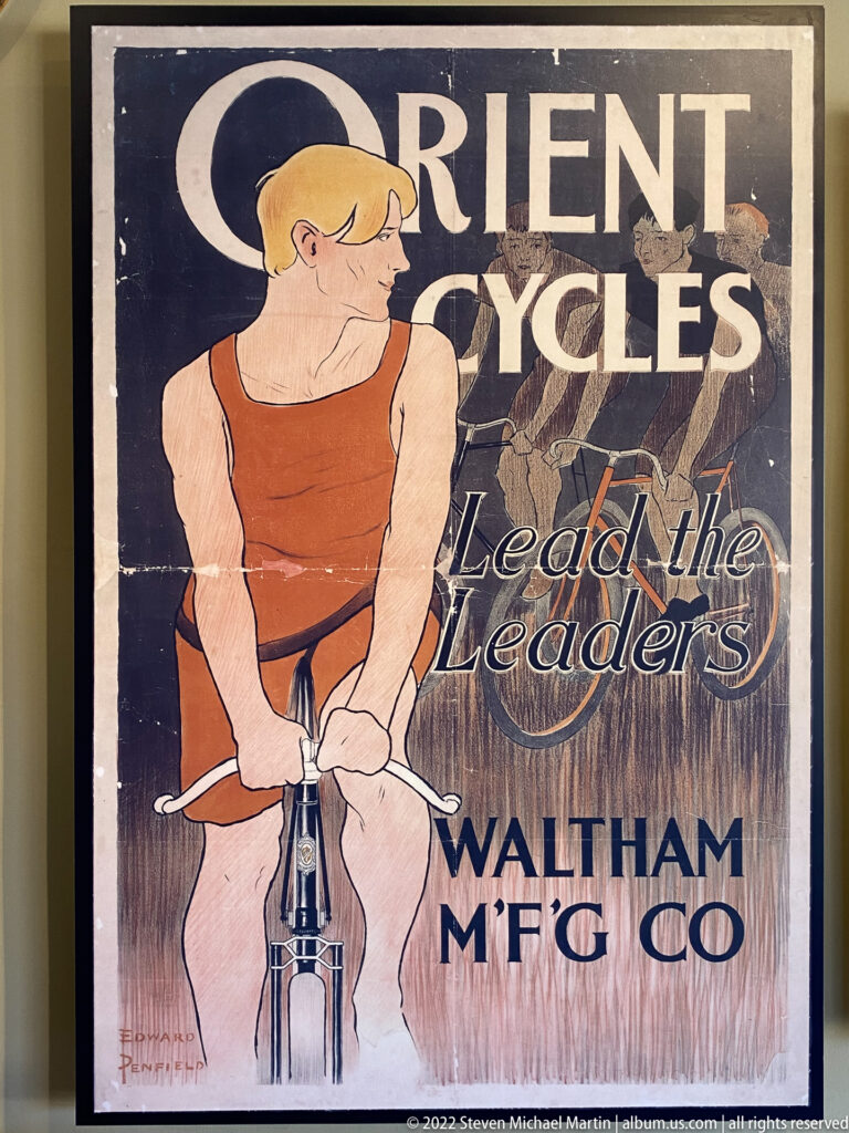 An Orient Cycles poster shows an illustrated cyclist above the slogan “Lead the Leaders.”