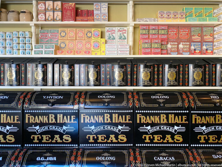 Colorful tea tins and grocery boxes line shelves, with Frank B. Hale tea packages prominent in front.