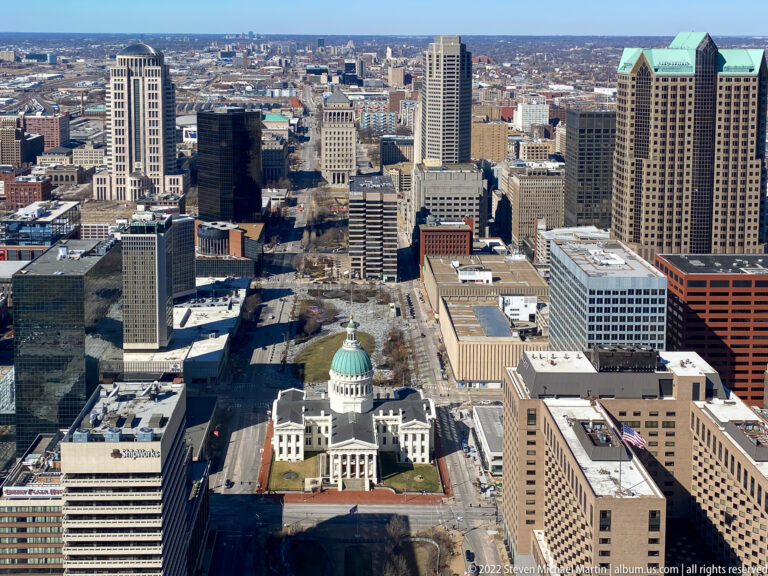 The green dome and pale façade of the Old Courthouse rise amid downtown towers.
