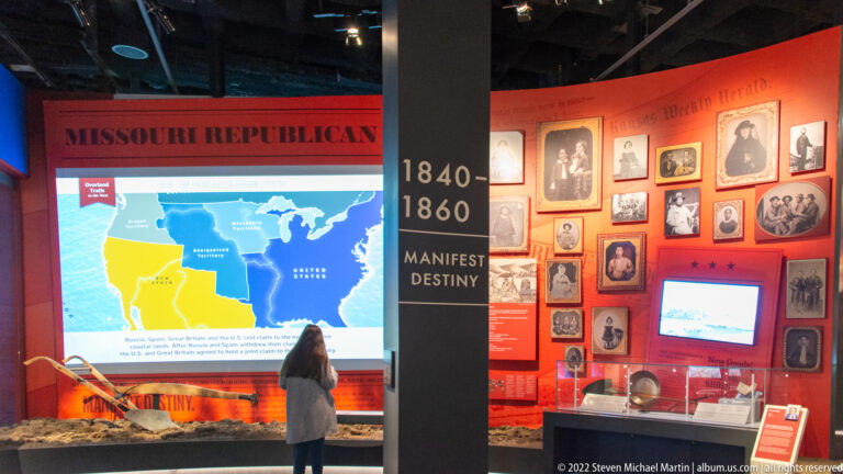 A visitor faces a western expansion map beside portraits and a timeline labeled “Manifest Destiny, 1840–1860.”