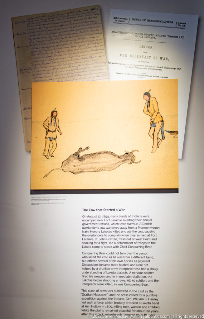 An exhibit illustration shows two armed figures near a large animal, above text identified as “The Great Hunt.”