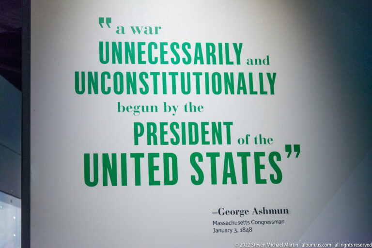 Green wall lettering quotes George Ashmun criticizing the war and identifies him as a Massachusetts congressman in 1848.