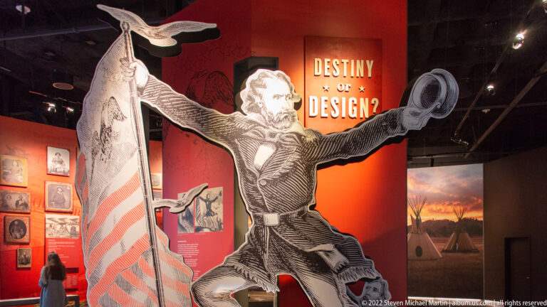 An oversized illustration shows a running figure carrying an American flag beside the words “Destiny or Design?”
