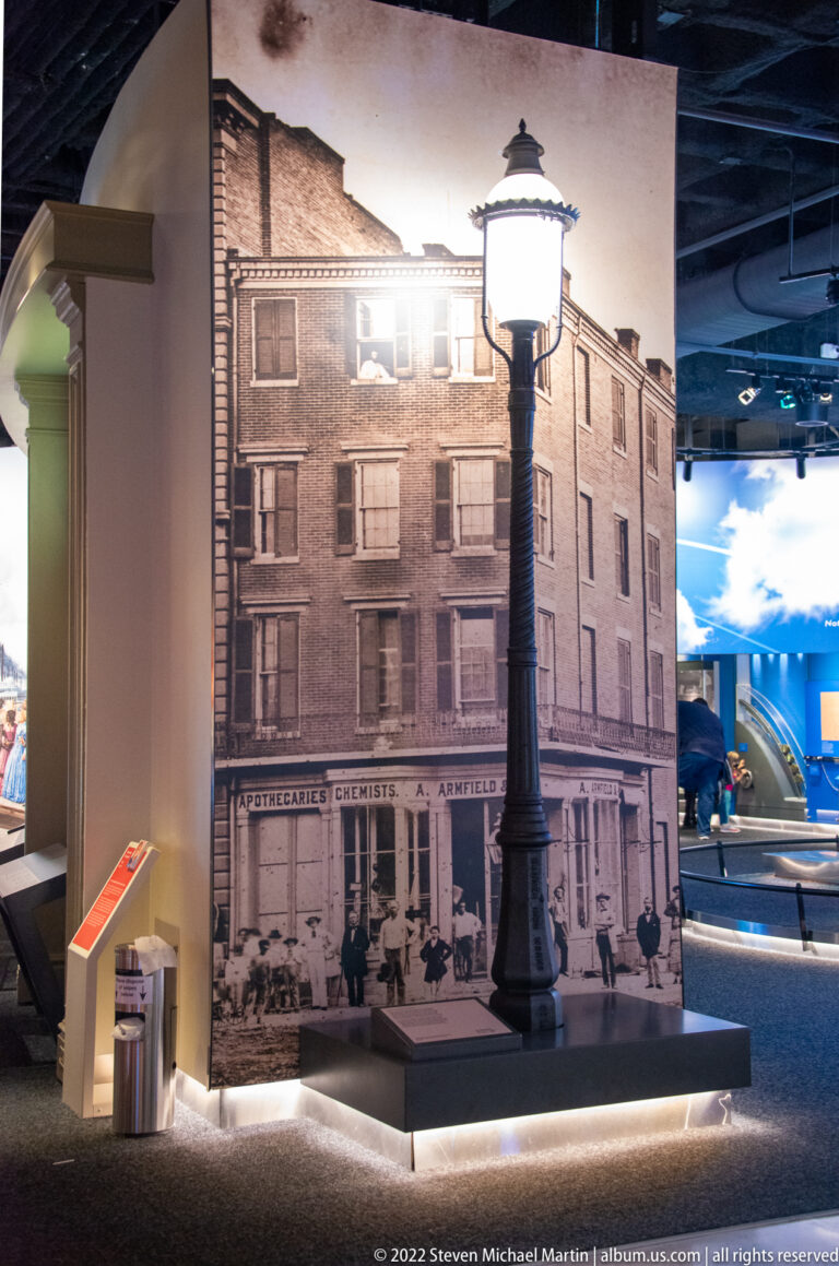 A historic storefront image with apothecary signage is paired with a freestanding streetlamp in the gallery.