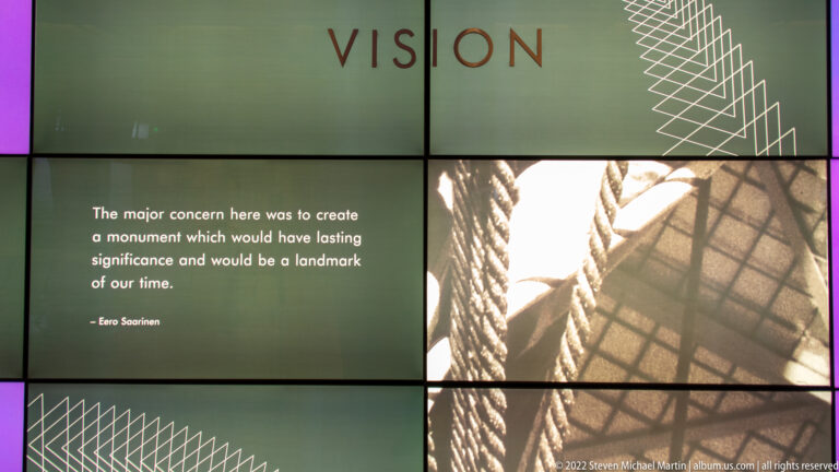 A Gateway Arch exhibit displays Eero Saarinen’s quotation about creating a lasting monument beside a construction photograph.