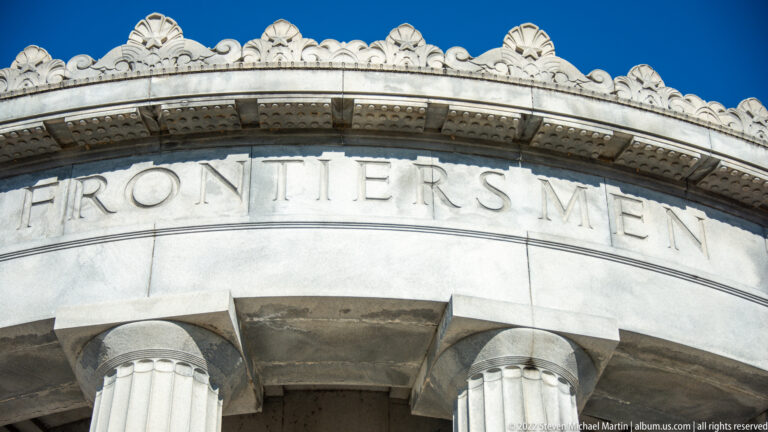 The word “Frontiersmen” is carved above column capitals and a coffered cornice.