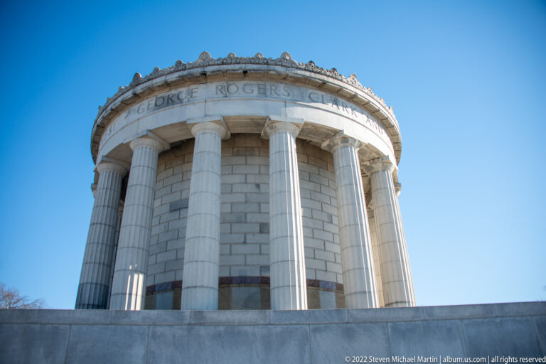 The memorial’s columns rise toward a curved band carved with George Rogers Clark’s name.