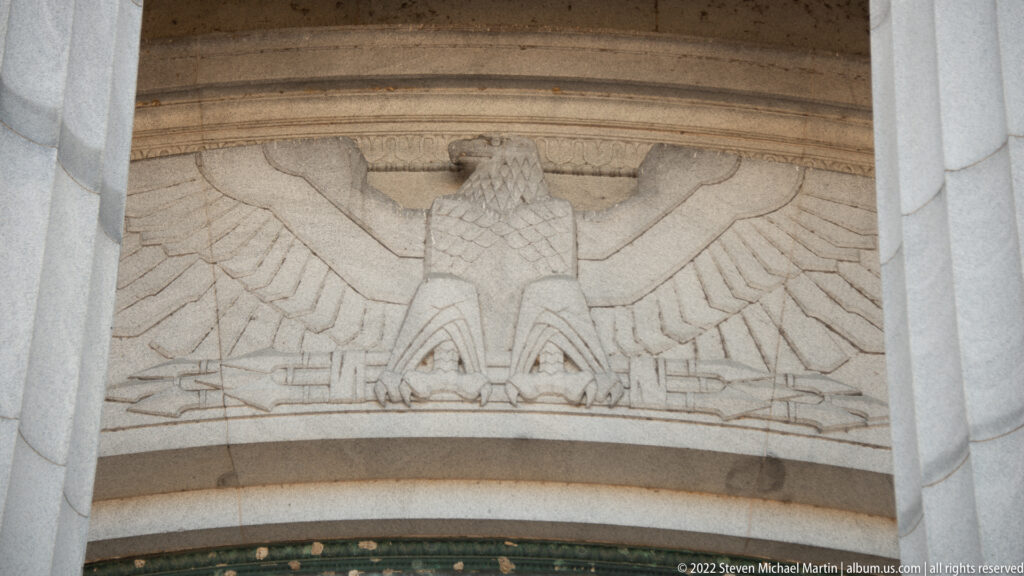 A spread-winged eagle is carved into a stone panel above the entrance.