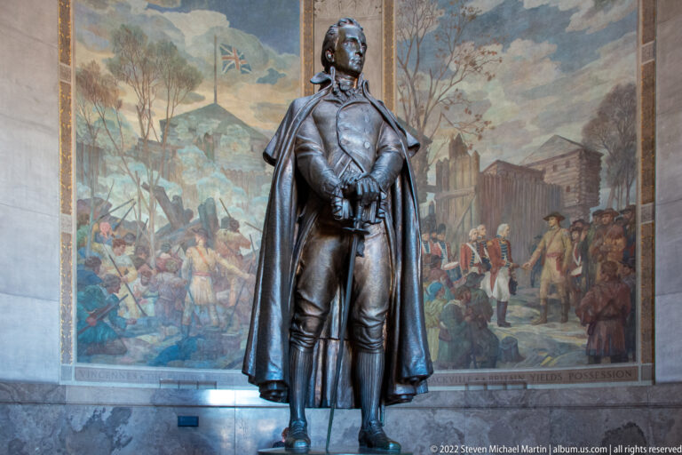 Bronze statue of George Rogers Clark stands before a mural labeled “Fort Sackville.”