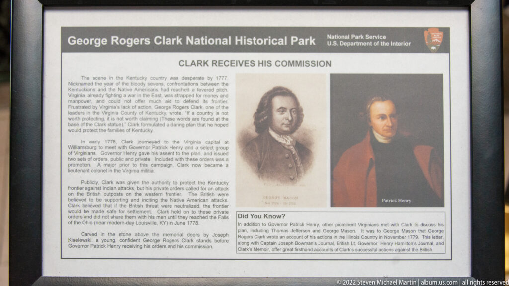 A museum panel titled “Clark Receives His Commission” pairs portraits of George Rogers Clark and Patrick Henry with explanatory text.