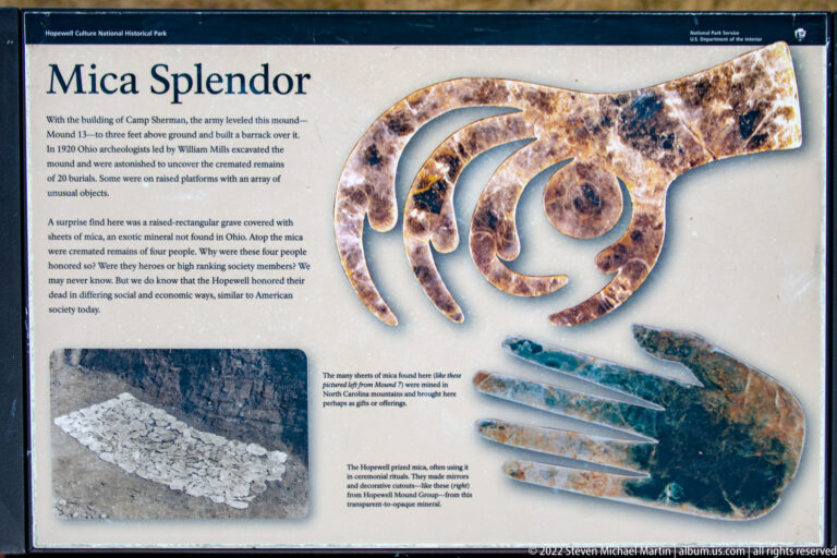 A museum panel displays copper cutout artifacts beside an excavation photograph and explanatory text.
